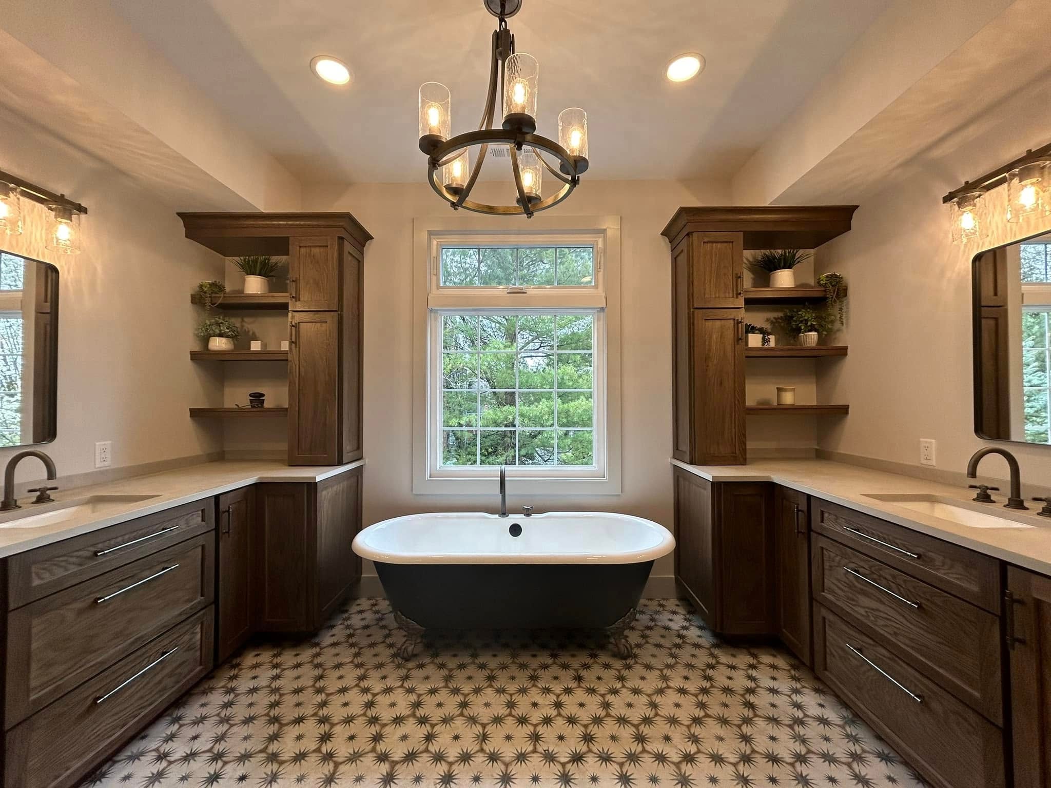 Symmetrical master bath with dual vanities, freestanding tub and chandelier