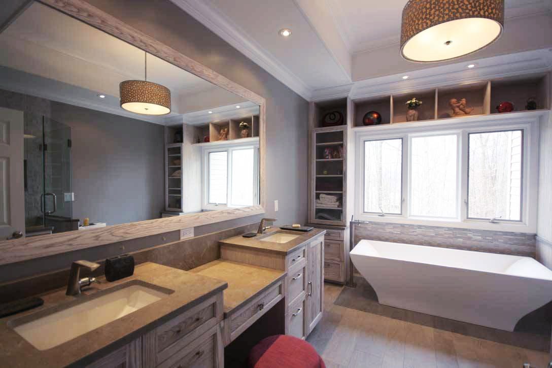 Spacious bathroom with double sinks, freestanding tub and built-in shelving