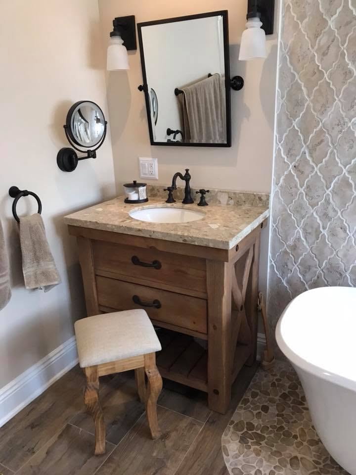 Farmhouse bathroom vanity with granite top, wood cabinet and arabesque tile
